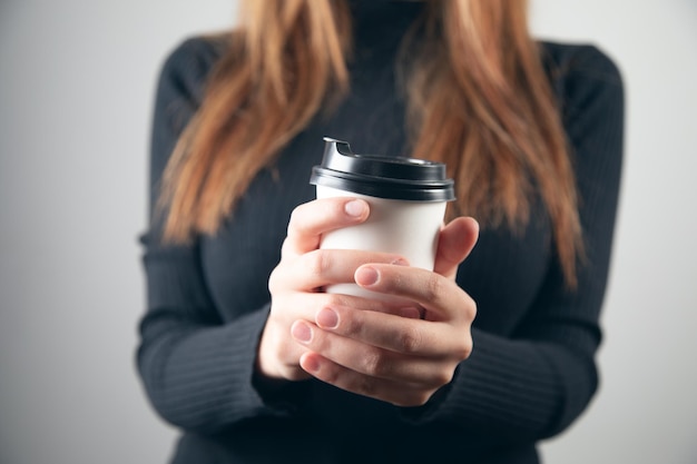 Maquete de mão feminina segurando um copo de papel de café