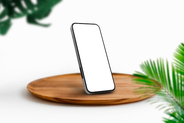 Maquete de telefone em um prato de madeira com parede de tijolos brancos com plantas