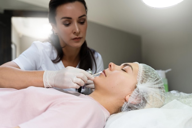 Maquilladora permanente profesional aplicando crema anestésica