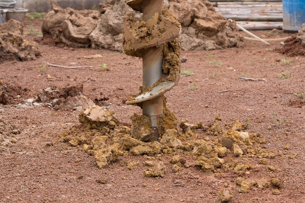 Foto máquina de construcción para perforar agujeros en el suelo