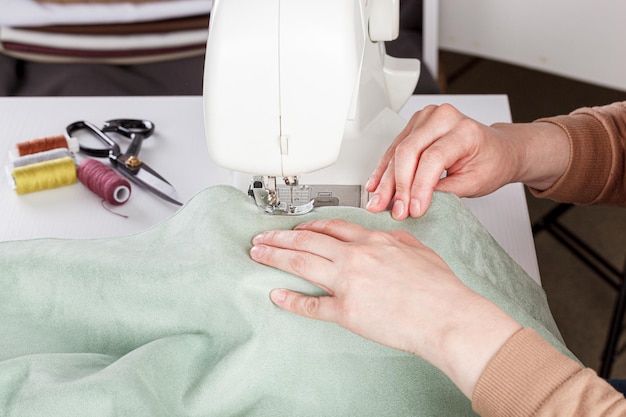 Máquina de costura costurando agulha de tecidos em um plano redondo fechado