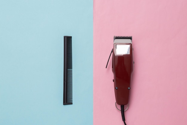 Máquina para cortes de cabelo pente em fundo azul rosa Barbearia Máquina de cortar cabelo Vista superior Postura plana