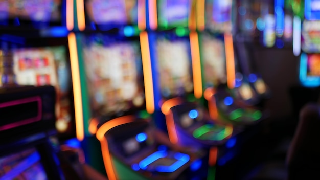 Las máquinas tragamonedas desenfocadas brillan en el casino de Las Vegas, Estados Unidos. Tragamonedas de juego de neón iluminadas.