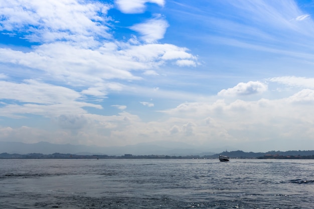 Mar azul e céu azul com nuvens