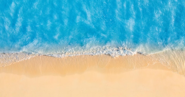 Mar de verão belas ondas, água do mar azul em dia ensolarado. Vista superior do drone. Vista aérea do mar
