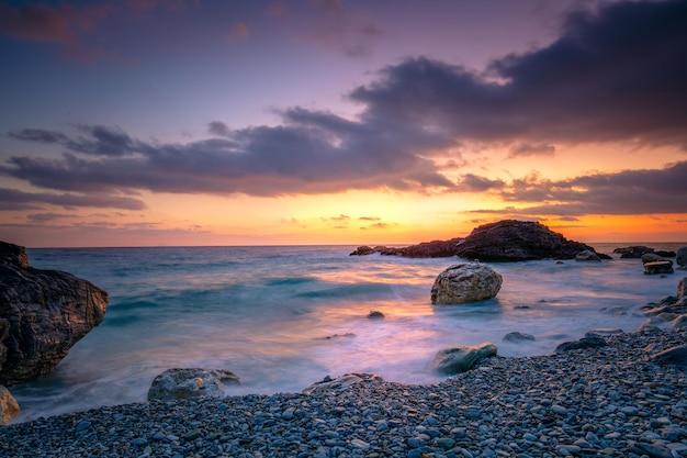 Mar Océano Hora del amanecer en el mar Grandes rocas La ola golpea la roca en la playa El agua del mar salpica hasta el cielo con el sol Atardecer Atardecer en el mar Paisaje de tormentas