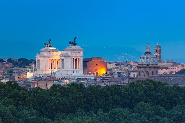 Maravillosa vista aérea de Roma con el Altar de la Patria y las iglesias por la noche en Roma, Italia