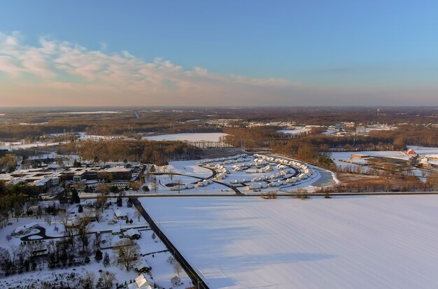 Maravilloso paisaje invernal casas de techo cubierto de nieve en la vista aérea con una pequeña ciudad americana residencial cubierto de nieve durante un día de invierno después de las nevadas