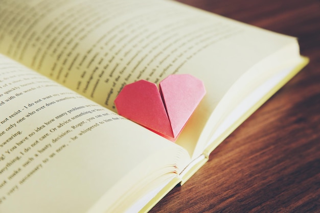 Marcador de coração para livro na mesa de madeira closeup