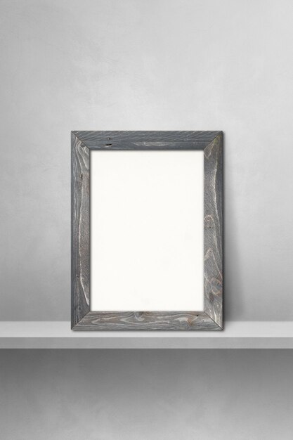 Foto marco de madera apoyado en un estante gris. ilustración 3d. plantilla de maqueta en blanco. fondo vertical