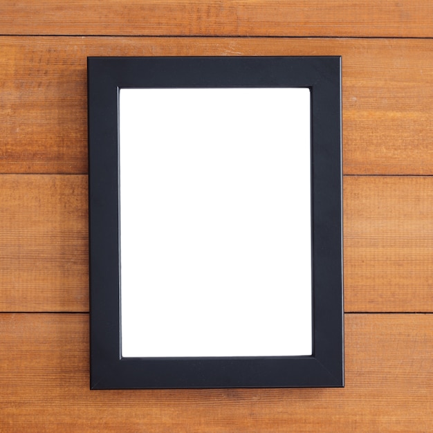 Foto marco de madera en blanco sobre la mesa. se puede usar para su texto o ilustración. vista superior