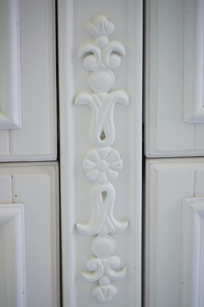 Foto marco de madera tallada con hermoso patrón pintado de colores blancos.