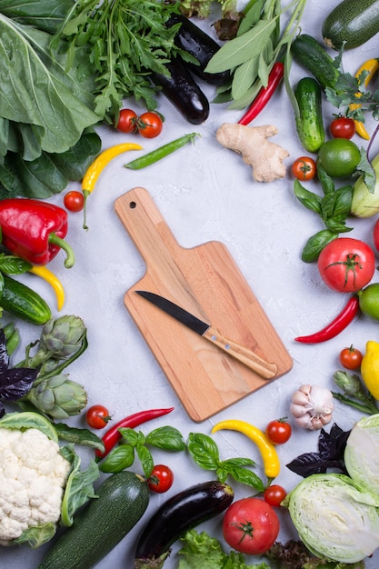 Marco de verduras orgánicas frescas sobre un fondo de hormigón gris. Vista superior de alimentos naturales saludables, espacio de copia. bok choy pimiento col verdes alcachofa calabacín pepino tomate ajo