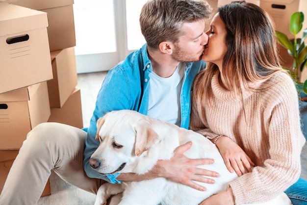 Marido e mulher e seu cachorro se mudando para uma nova casa