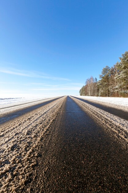 Marrón nieve sucia, tirado en la carretera en invierno