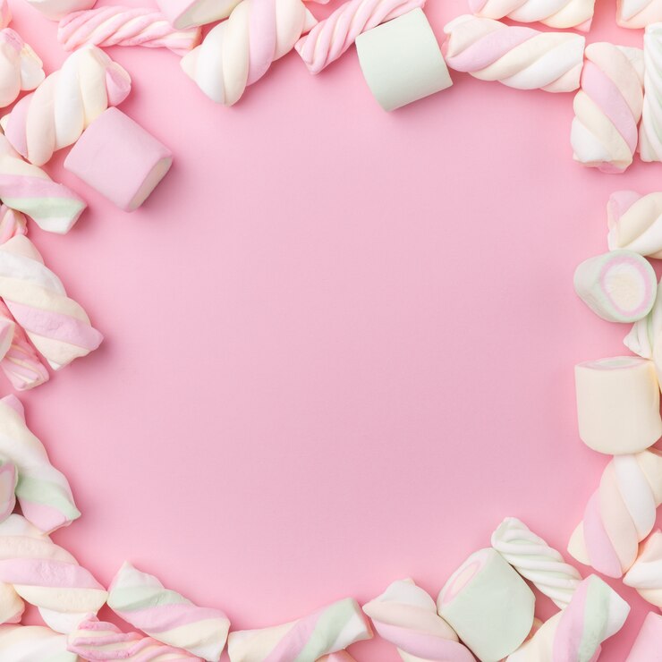 Foto marshmallows em fundo rosa suave