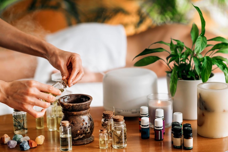 Foto masaje de aromaterapia ayurveda vertiendo aceite aromático en difusor de aceite esencial