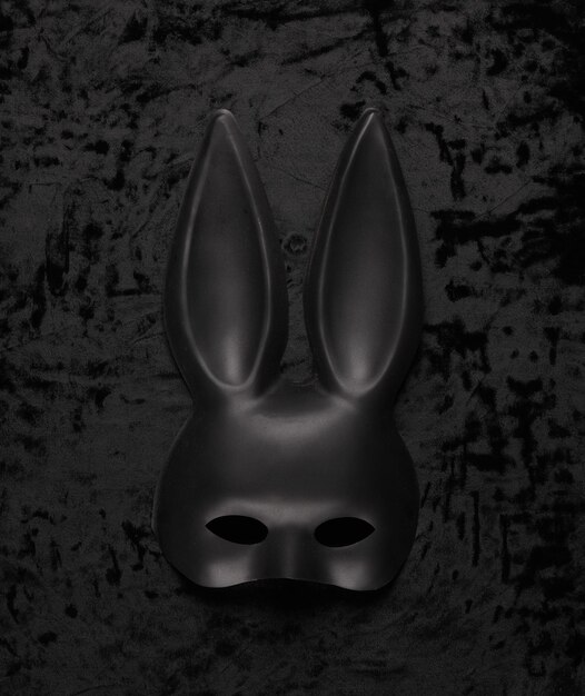Foto máscara de conejo negro sobre terciopelo negro