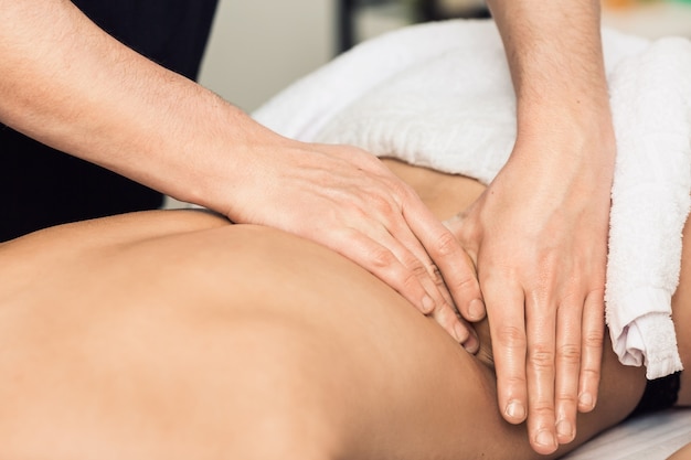 Masseur Mann macht Rückenmassage.