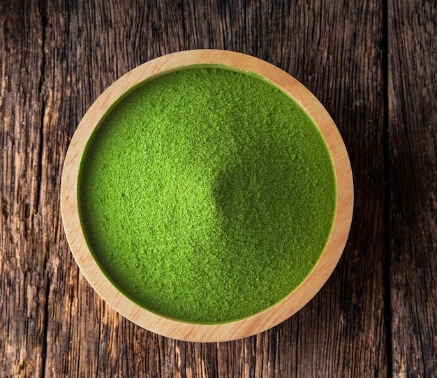 Matcha-Grüntee-Pulver in einer Schüssel auf Holztisch