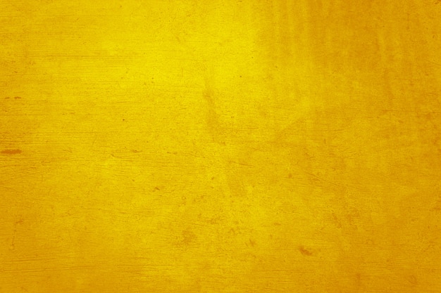 Foto material de hormigón o cemento amarillo en textura de pared abstracta.