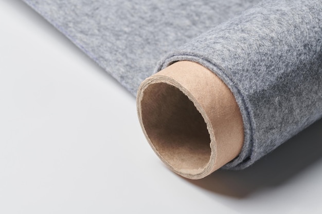 Material têxtil de feltro macio, cor cinza, textura colorida, rolo de tecido fechado