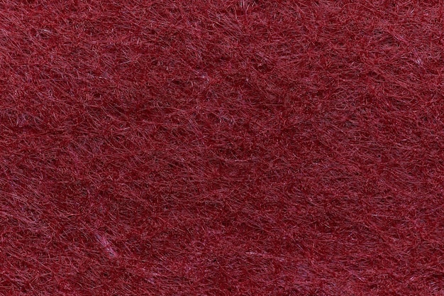 Material têxtil de feltro macio, cores rosa vermelhas, textura colorida, aba de tecido, closeup