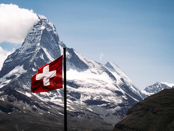 Foto matterhorn mit schweizer flagge und klarem himmel im hintergrund