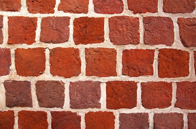 Mauer aus roten Backsteinen. Alter Backsteinmauerhintergrund