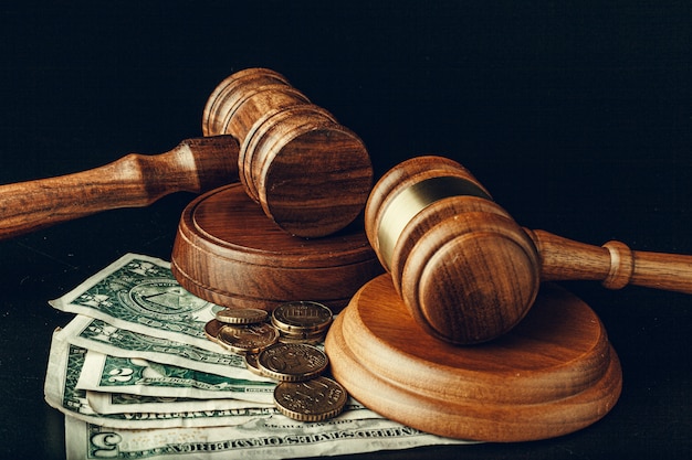 Mazo de madera del juez en el primer de los billetes de banco del dólar de EE. Concepto de corrupción de justicia