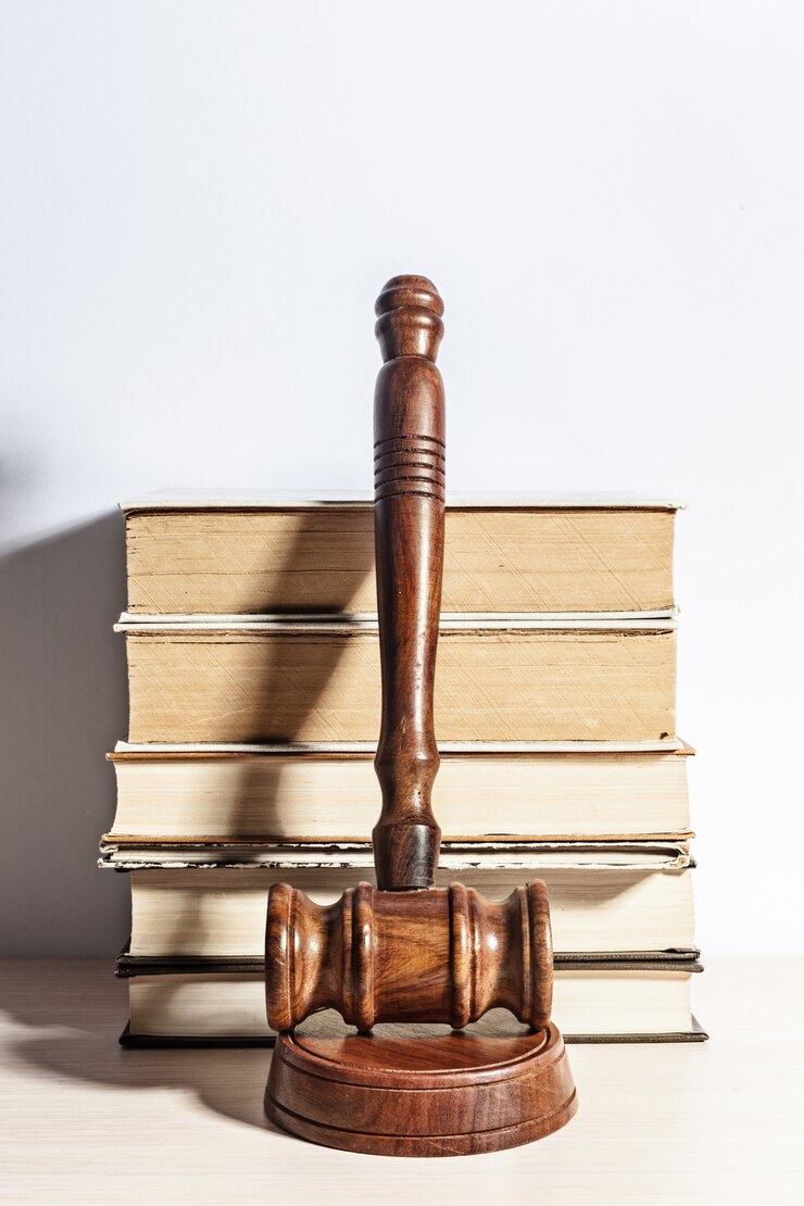 Foto mazo de madera sobre pila de libros