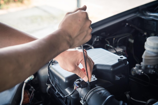 Foto mecánico de automóviles comprobando el enfoque selectivo del ingeniero de automóviles