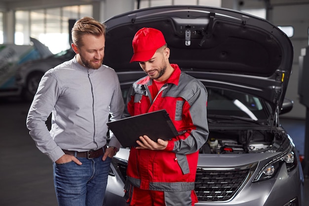 Mecânico de automóveis e cliente em serviço de conserto