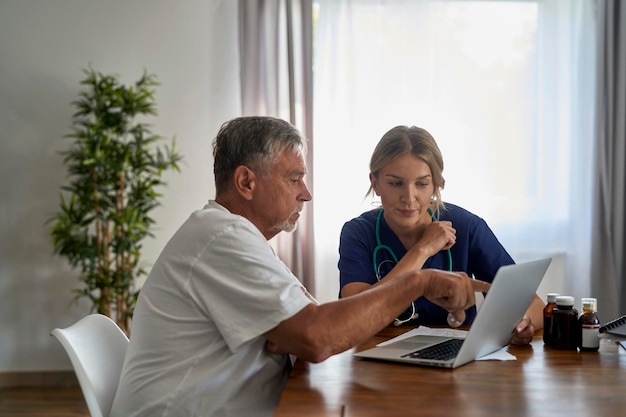 Médica caucasiana analisando exames médicos com paciente idoso em visita domiciliar