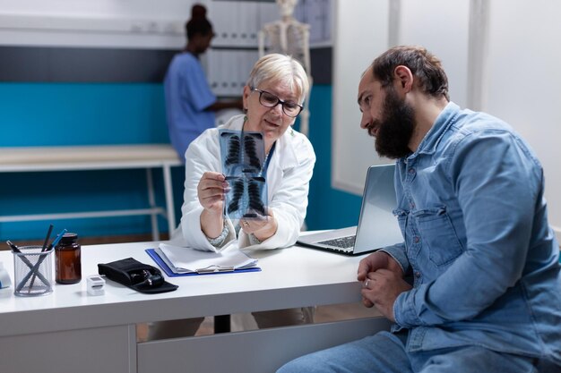 Foto médica discutiendo con un paciente en la clínica