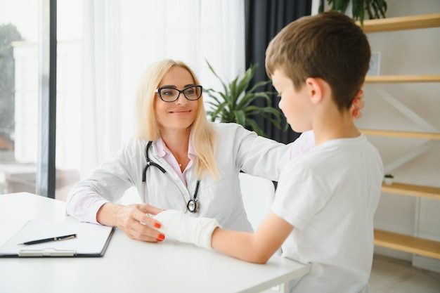 Médica e menino com um braço quebrado