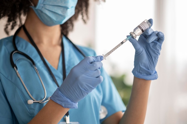 Foto médica preparando a vacina para um paciente