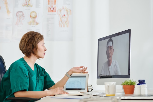 Médica usando plataforma de telemedicina para se comunicar com paciente doente