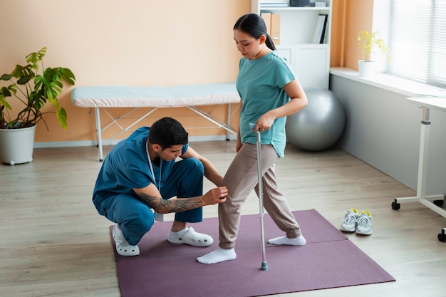 Foto médico ajudando paciente durante a reabilitação