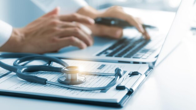 el médico analiza el informe médico examen físico exhaustivo grabación de datos del paciente con computadoras portátiles