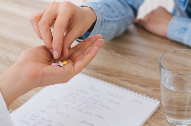 Médico dando pílulas para seu paciente em seu escritório