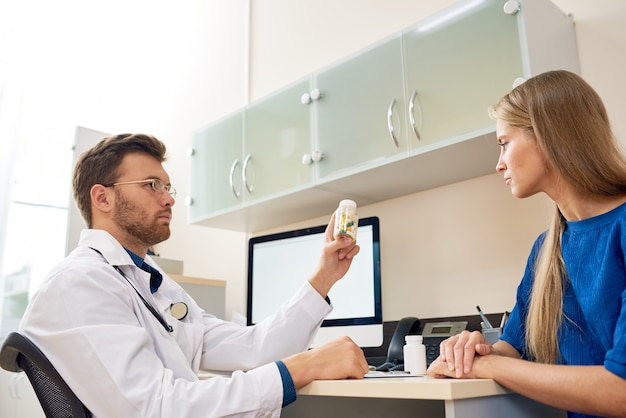 Médico dando vitaminas ao paciente