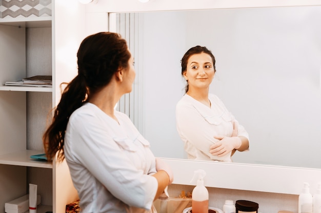 Médico de esteticista de mulher no trabalho no centro de bem-estar. Retrato de uma jovem cosmetologista profissional feminina.