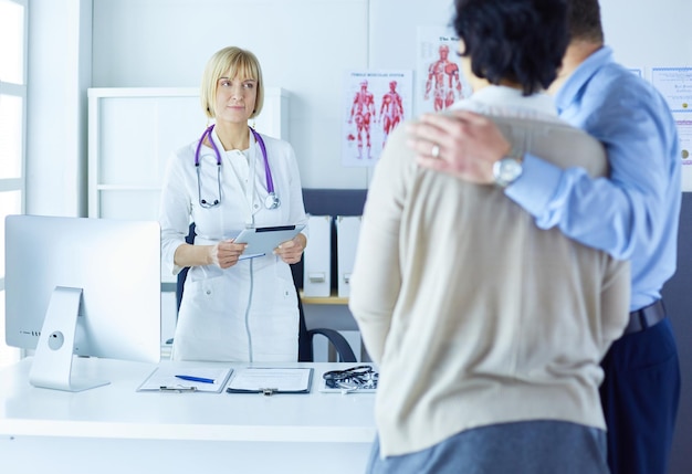 Médico e jovem casal pacientes no hospital