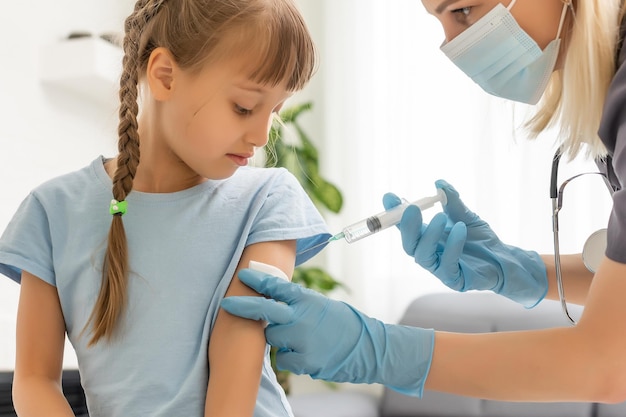 Foto el médico hace una vacunación infantil.