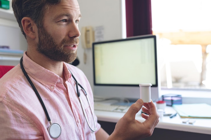 Foto médico masculino prescribiendo pastillas a su paciente en la sala de la clínica