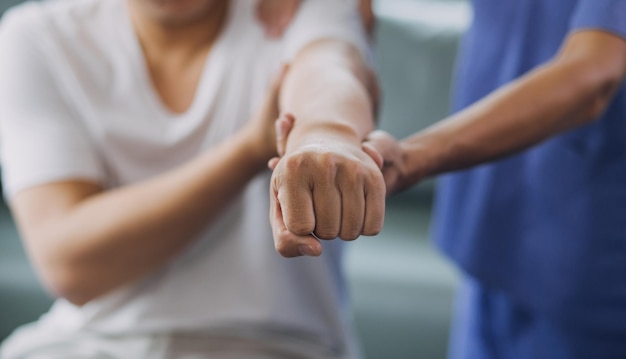 Foto médico o fisioterapeuta que trabaja examinando el tratamiento del brazo lesionado de un atleta que se estira y hace ejercicio haciendo el dolor de la terapia de rehabilitación en la clínica