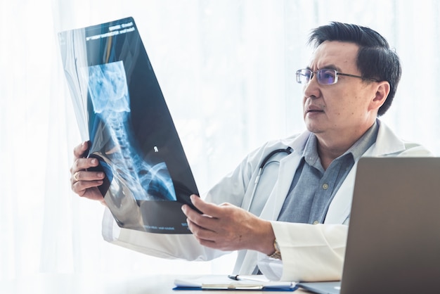 Médico que trabalha com dados de saúde do paciente no escritório do hospital.