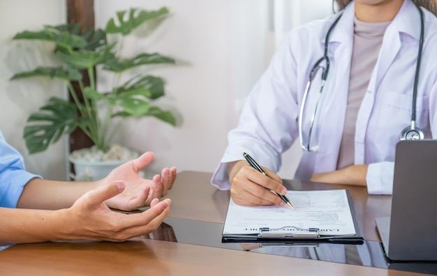 Foto médico sosteniendo una pluma y explicando los resultados del examen al paciente cuidado de la salud y chequeo médico