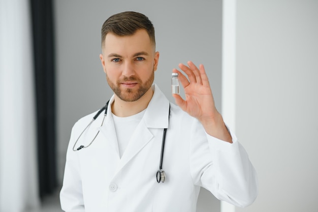 El médico sostiene la vacuna para un paciente